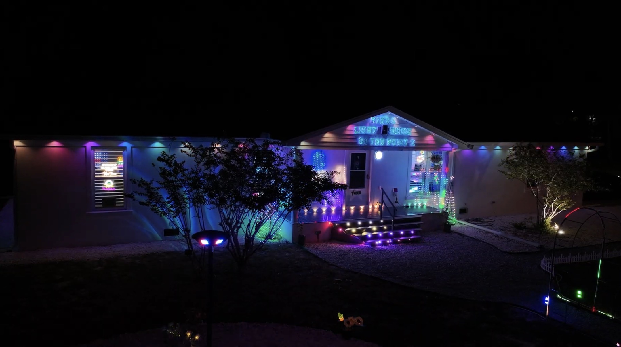 The retreat exterior glowing with color-changing lights at night